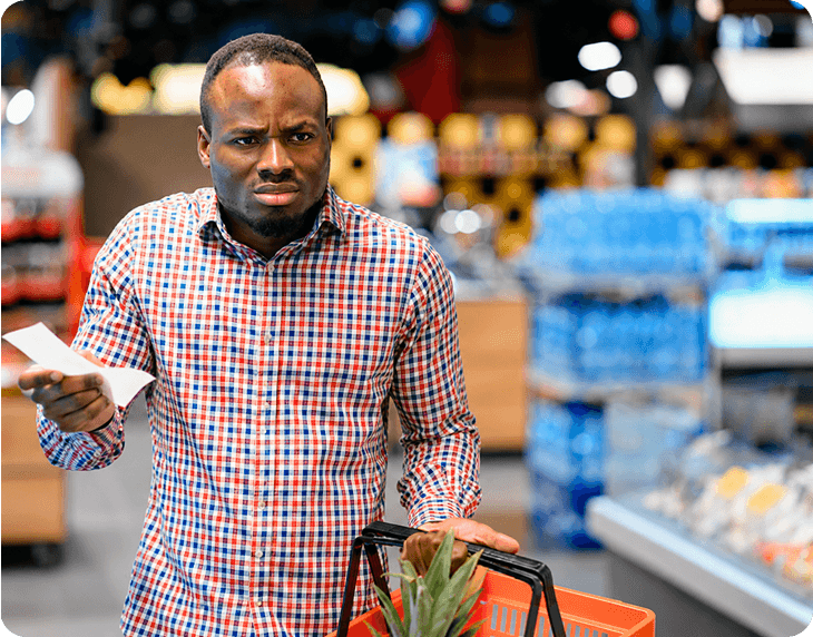Shopper checking prices in a supermarket